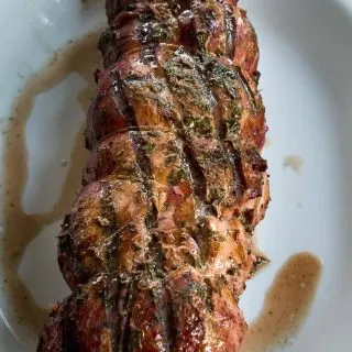 Grilled Pork Tenderloin with Peach Rum Sauce sounds pretty decadent but is easy to prepare, perfect for entertaining and absolutely delicious to eat! HostessAtHeart.com