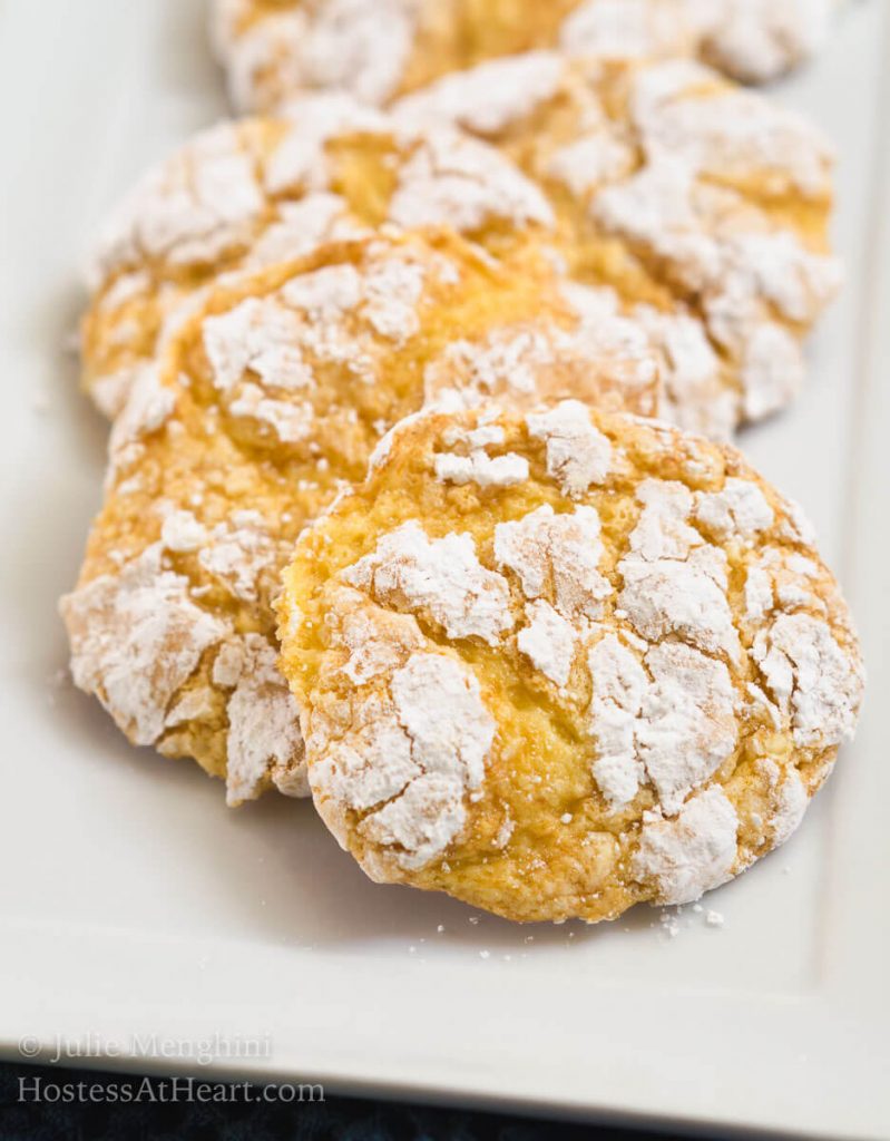 A plate of Lemon Snowflake Cookies dusted with powdered sugar - Hostess At Heart