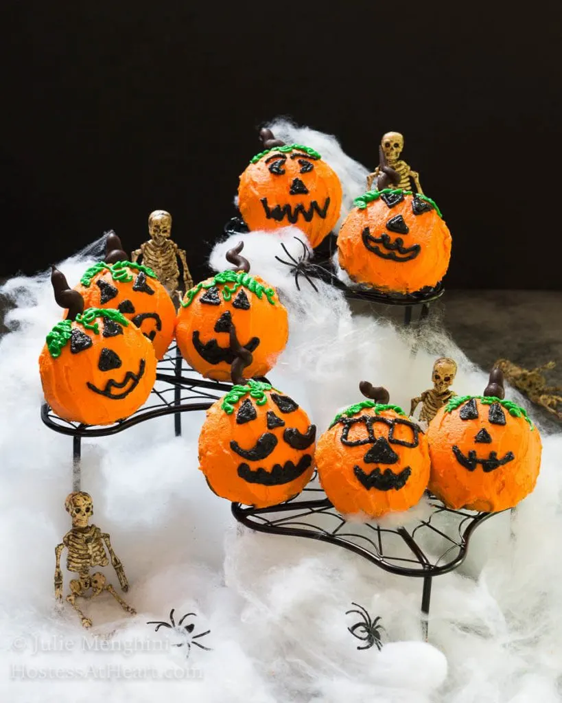 Homemade Chocolate Cake pumpkins surrounded by spider webs, spiders, and skeletons.