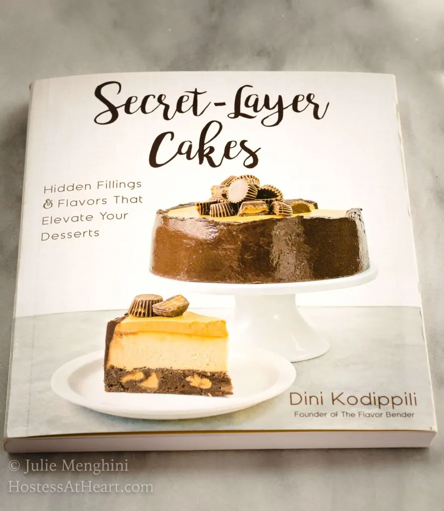 Photo of the cover of a cookbook titled Secret-Layer Cakes by Dini Kodippili.