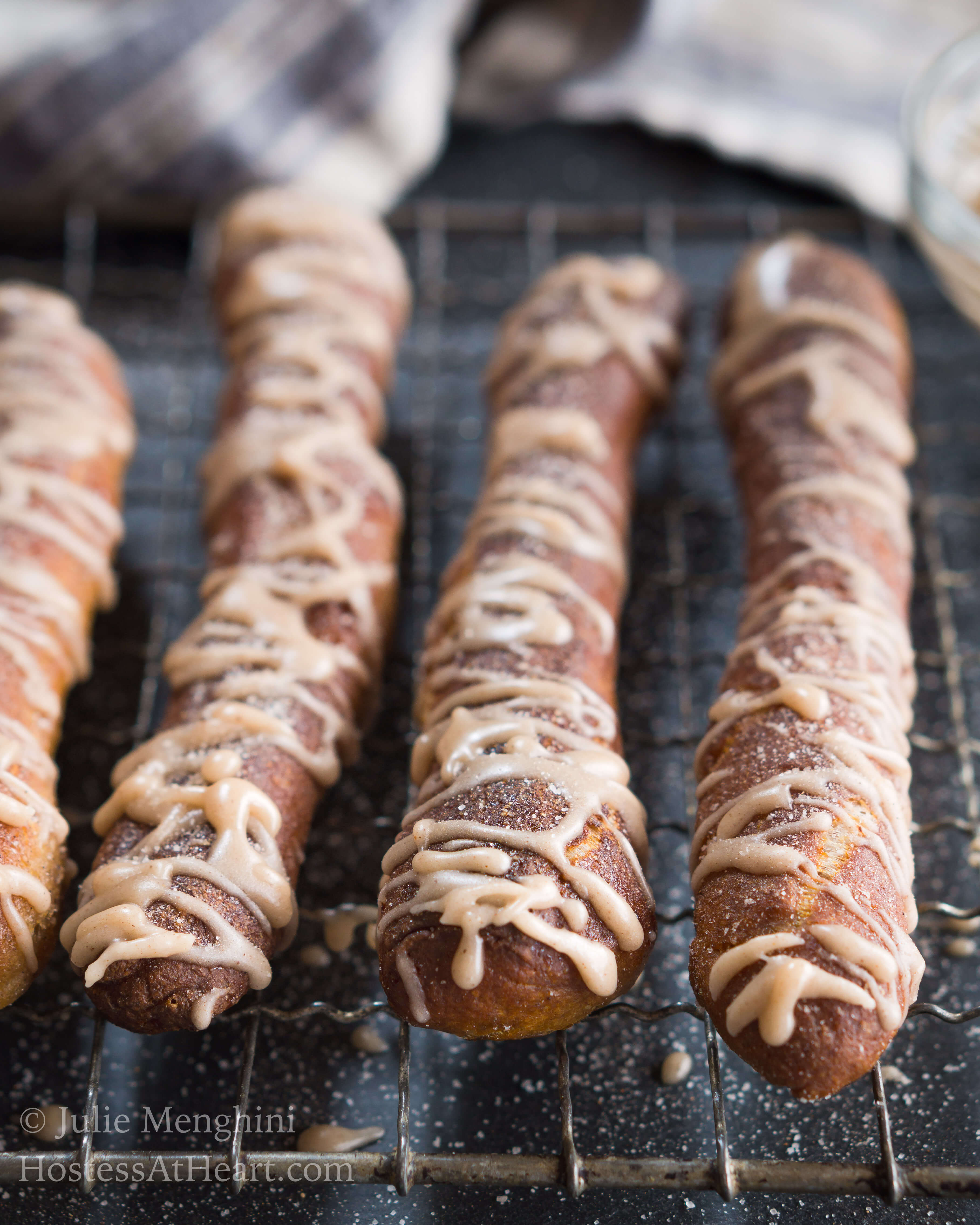 Cinnamon Sugar Soft Pretzel recipe is a made with a pretzel dough slightly sweetened with brown sugar and warm cinnamon and finished with a cinnamon glaze drizzle. | HostessAtHeart.com Cinnamon Sugar Soft Pretzel Recipe