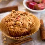 top view of a Rhubarb Oat Muffin with raw pieces of rhubarb in a bowl