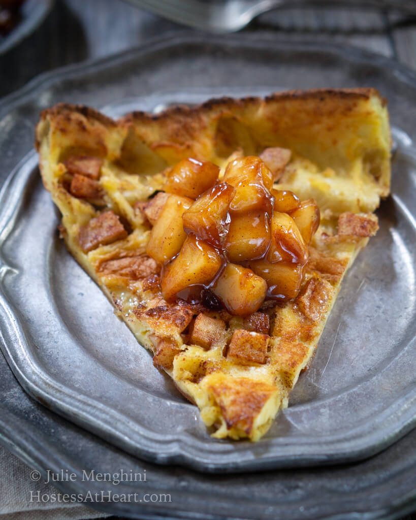 Close up view of slice of Apple Dutch Baby Pancake with Apple topping