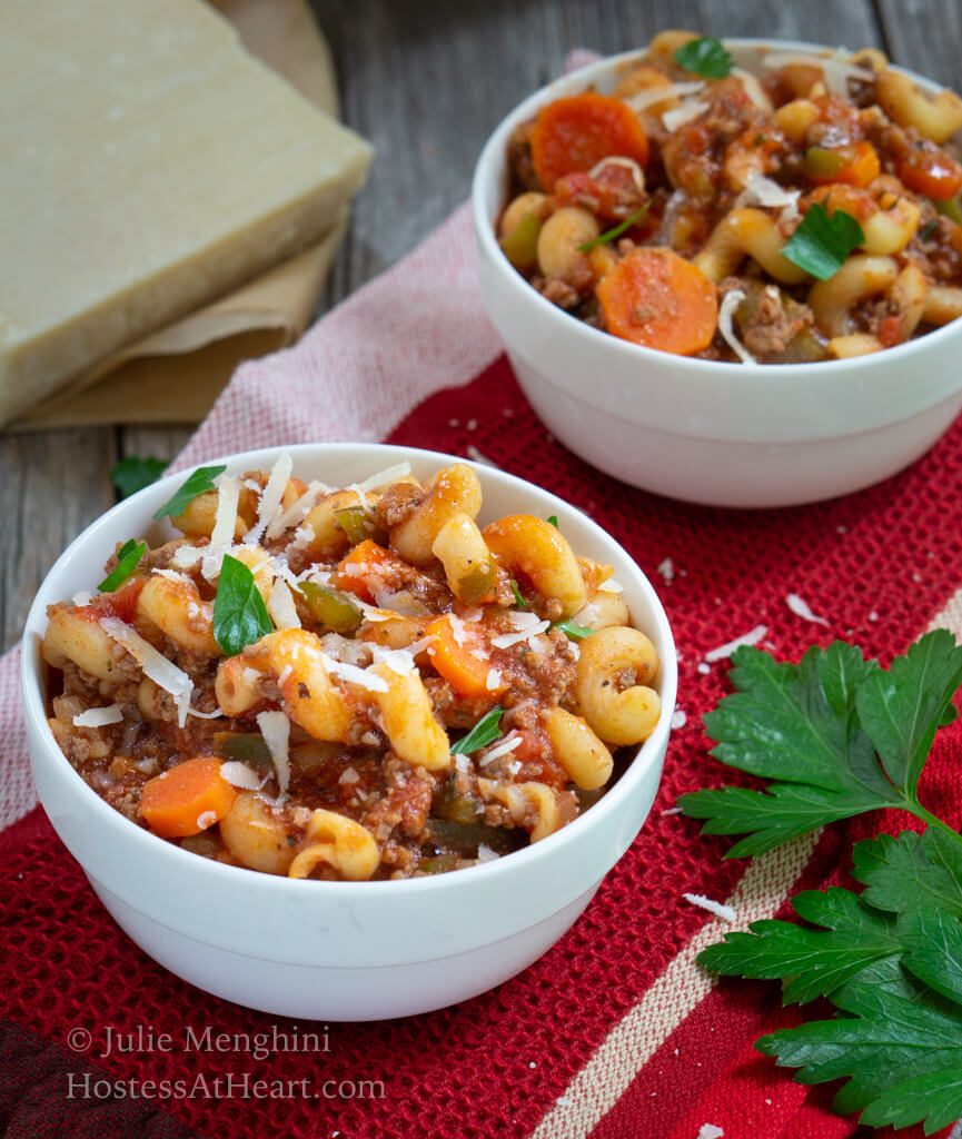 Top view of two bowls of goulash in white bowls