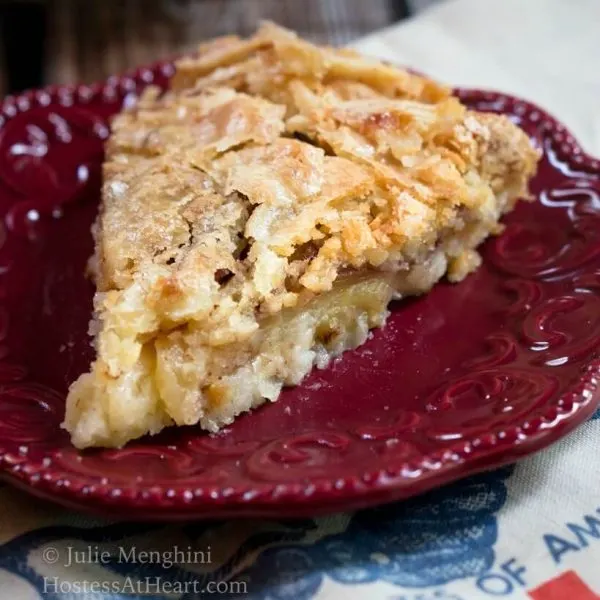 Close up of a Swedish Apple Pie slice on red plate