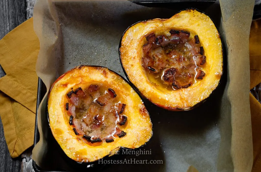 Side by side halves of baked acorn squash filled with bacon