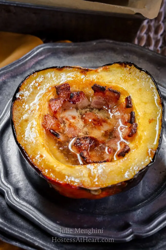 Top view of a half baked acorn squash filled with bacon