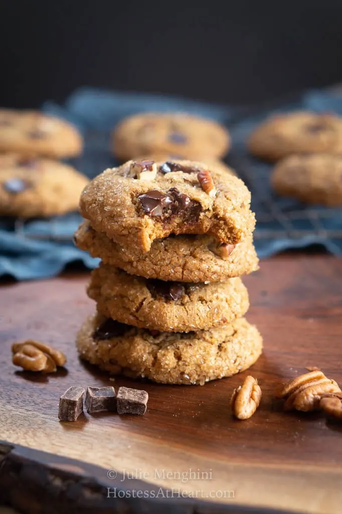 Stack of 4 cookies with a bite out of the top one.