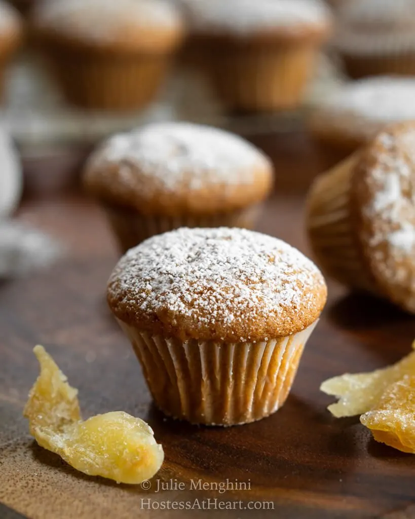 Central head on view of a mini ginger spice muffin with more muffins behind