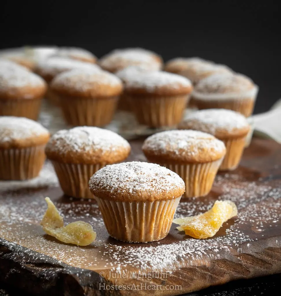 Sugar dusted mini muffins on a wood cutting board