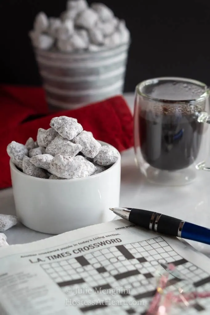 Distance shot of two containers of puppy chow with crossword puzzle in front