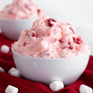 Close up side view of Pineapple Cherry Fluff with another bowl in the background