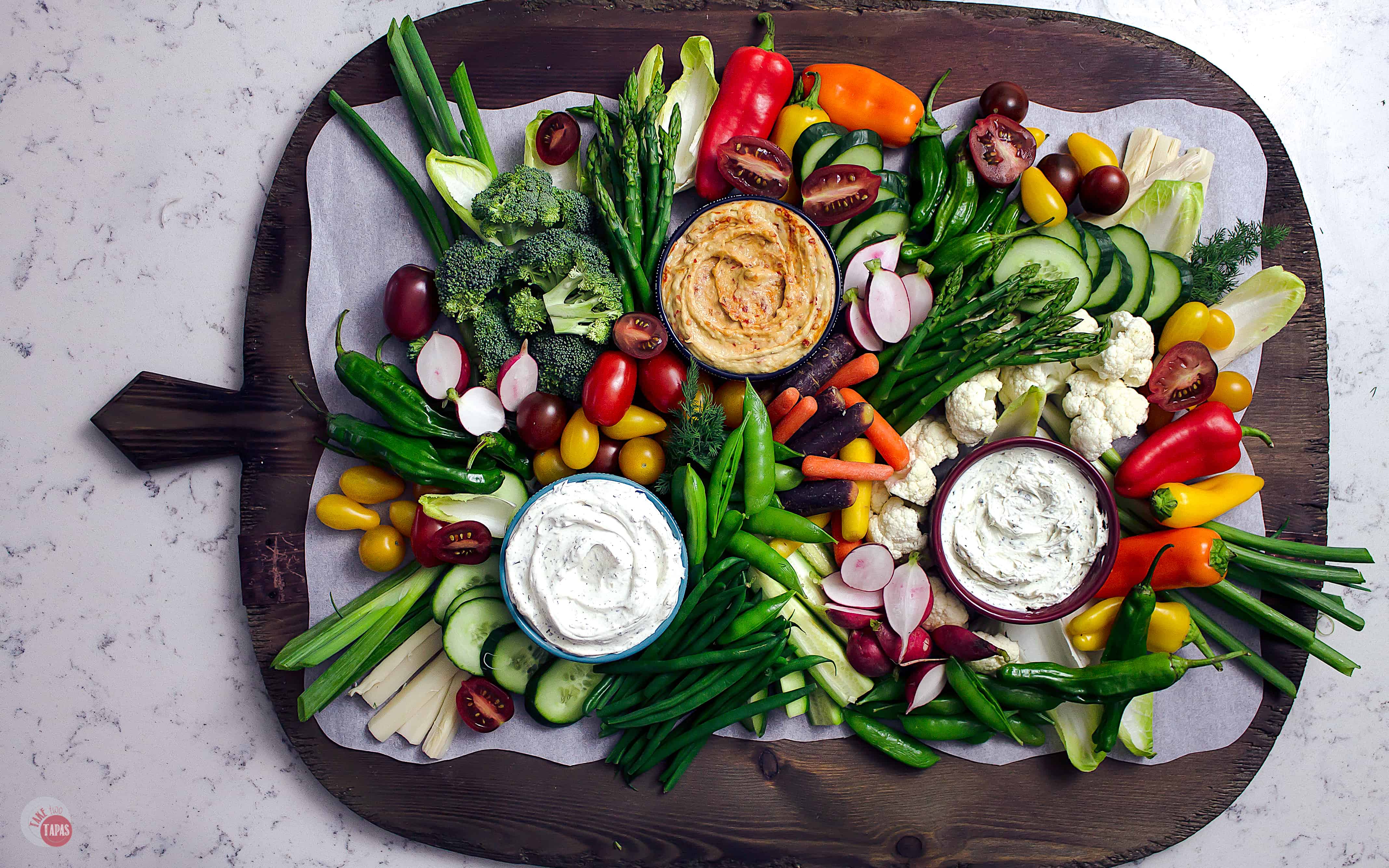 A beautiful Crudite Tray filled with vegetables and dips perfect for any gathering.