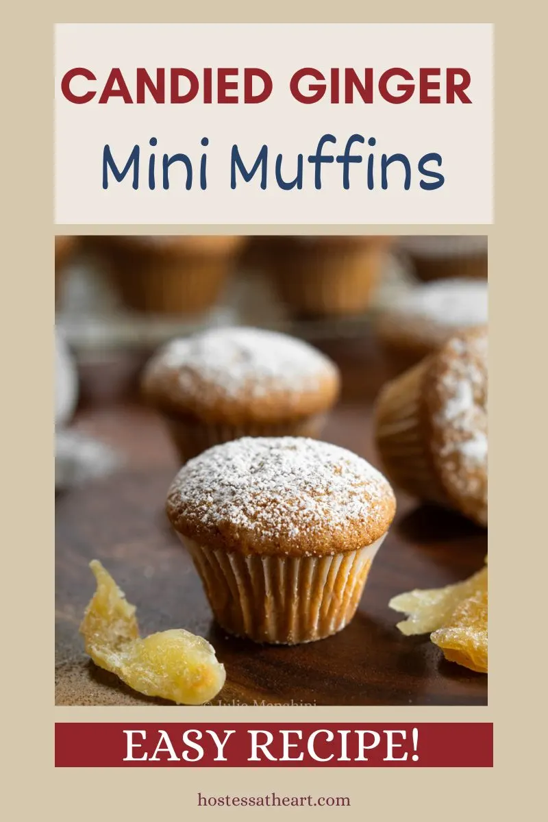 Sideview of a mini muffin dusted with powdered sugar surrounded by pieces of candied ginger Hostess At Heart