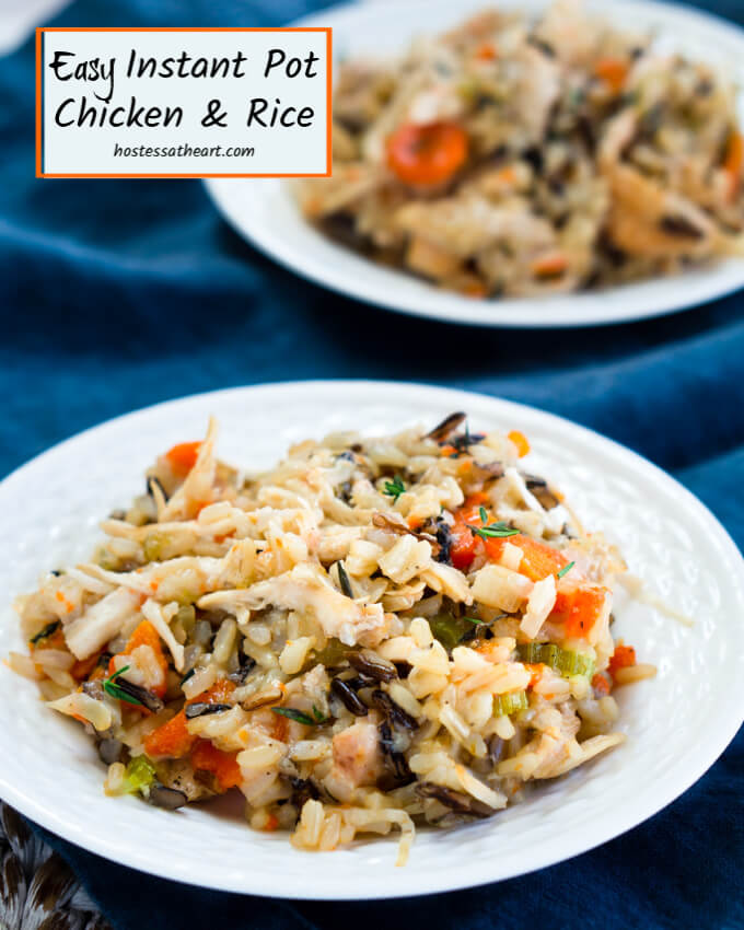 A white plate of chicken and rice filled with carrots, onions, and herbs over a blue cloth. A second plate is in the background. The title \"Instant Pot Chicken and Rice appear in the top left corner.