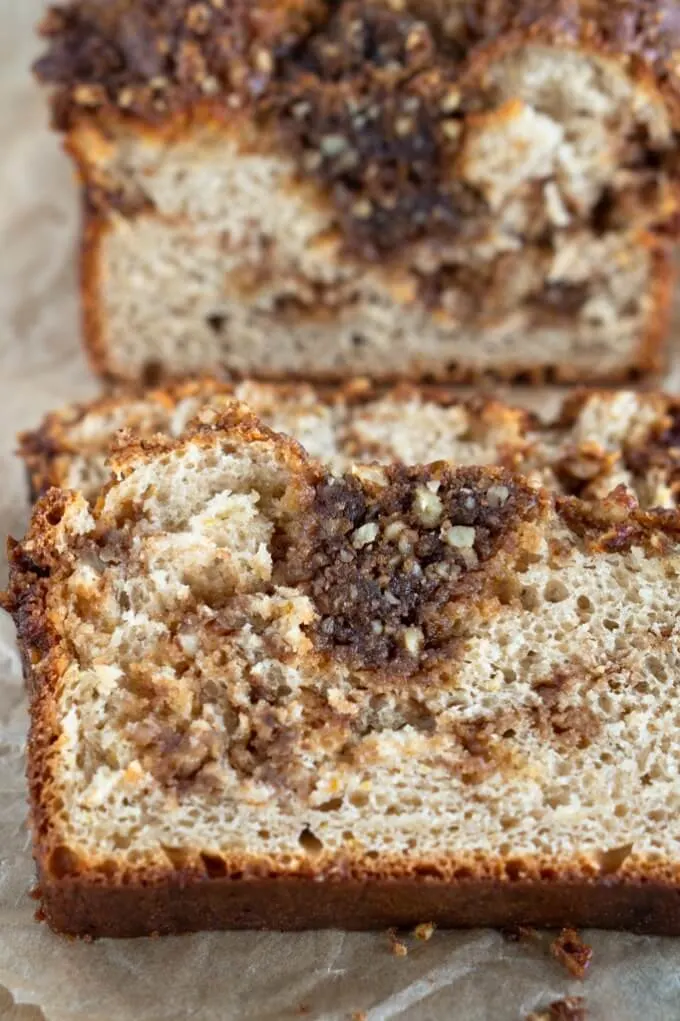 The inside crumb of this slice or Orange-Pecan Streusel Coffee Cake is soft and tender and loaded with sweet brown sugar pecan streusel.
