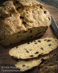 Easy Soda Bread with Raisins is a browned round loaf of dense bread dotted with raisins