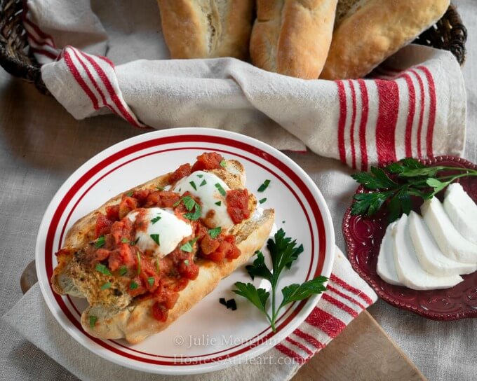 A hoagie roll filled with breaded chicken meatballs topped with melted mozzarella, marinara and parsley.