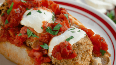 A hoagie roll loaded with fresh marinara, melted mozzarella over chicken parmesan meatballs