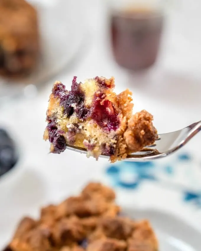 A bite of blueberry buckle loaded with berries and streusel