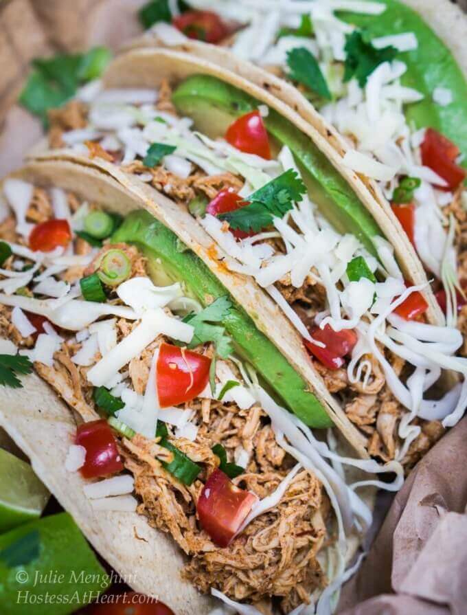 These spicy chipotle tacos are stuffed with shredded chicken, avocado, tomatoes and cabbage