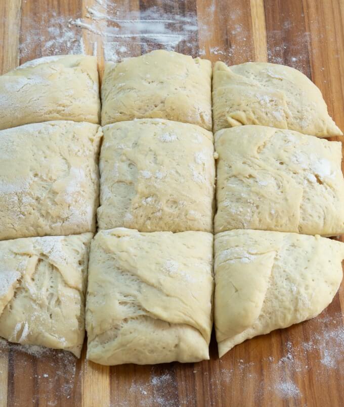 Ciabatta bread dough sliced vertically and horizontal in equal-sized pieces prior to forming.
