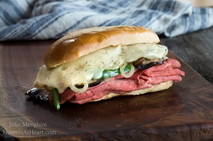 Whole Italian sandwich with glistening buttered bun, loaded with rare prime rib, al dente vegetables and melted cheese.