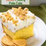 Bright yellow slice of cake with a whipped cream topping sprinkled with crushed lemon cookies on a white plate. The title "Lemon Pudding Poke Cake" runs across the top.