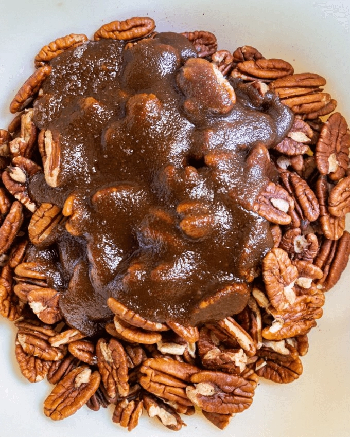 Top view of pecans topped with a butter brown sugar caramel sauce