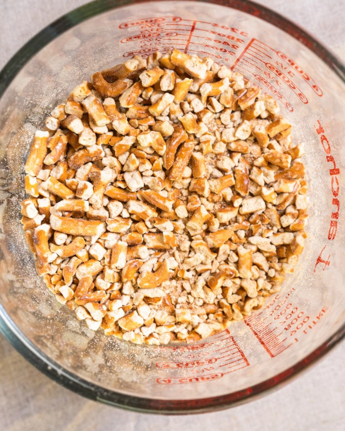 Measuring cup full of crushed pretzels