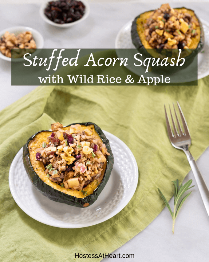 Half of an Acorn Squash stuffed with wild rice and apples on a white plate sitting over a green napkin with the recipe title over the top.