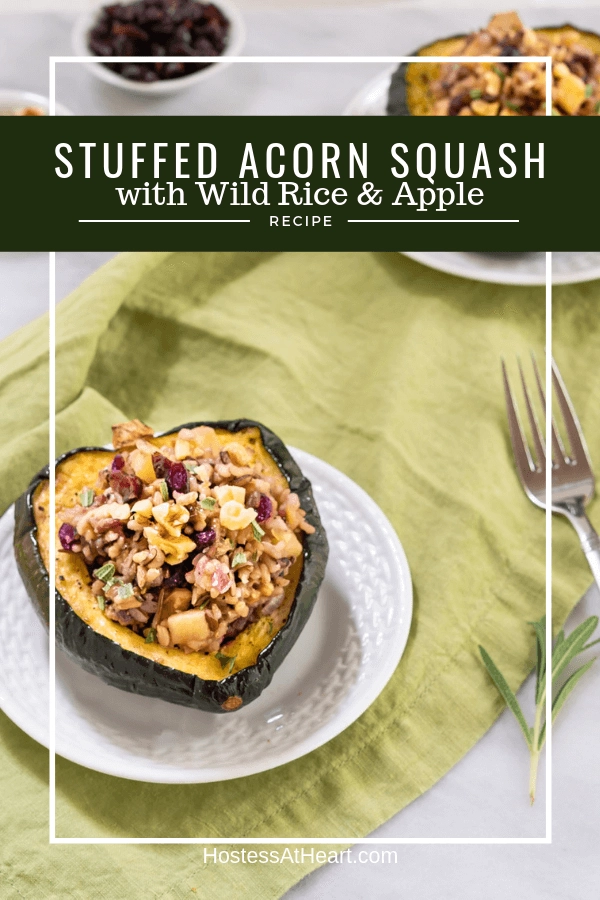 Half of an Acorn Squash stuffed with wild rice and apples on a white plate sitting over a green napkin with the recipe title over the top.