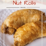 Close up of two baked nut rolls sitting on a white plate.