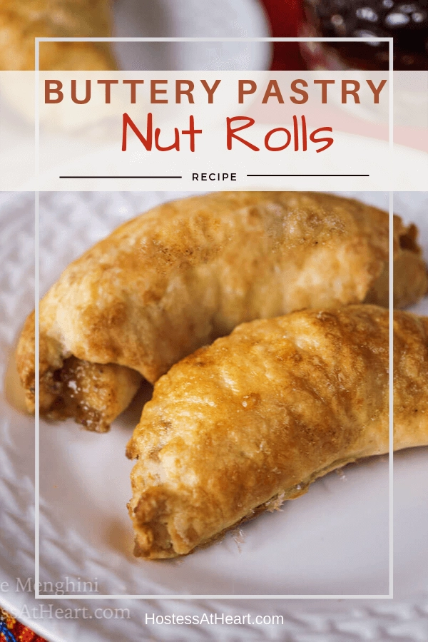 Close up of two baked nut rolls sitting on a white plate.