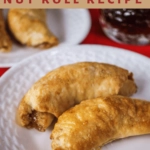 Title text on top of a picture of two browned nut rolls on a white plate over a red napkin.