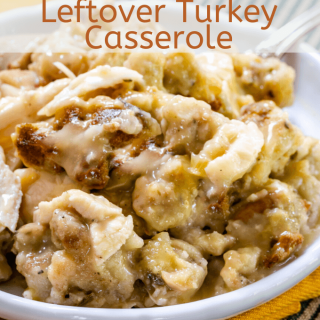 Chunks of leftover turkey and dressing in creamy chicken soup on a white plate sitting on a gold napkin and a green striped napkin with the title "Leftover Turkey Casserole" over the top.