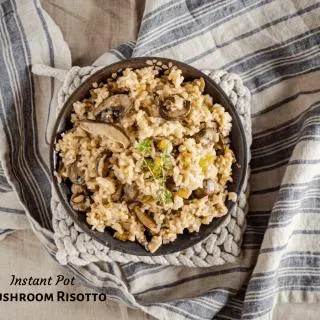 Top-down view of a bowl of mushroom risotto topped with a sprig of fresh thyme sitting on a blue striped towel. The title banner "Instant Pot Mushroom Risotto" appears in the left bottom corner.