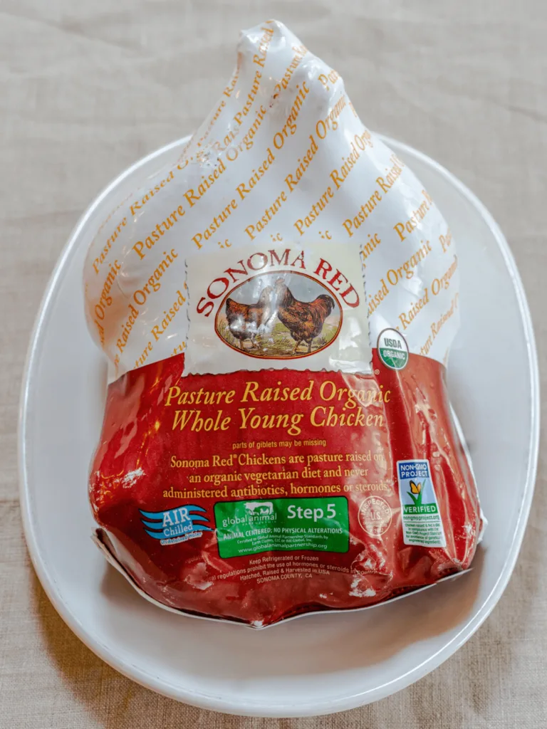 A whole chicken in the packaging from Sonoma Red Chicken