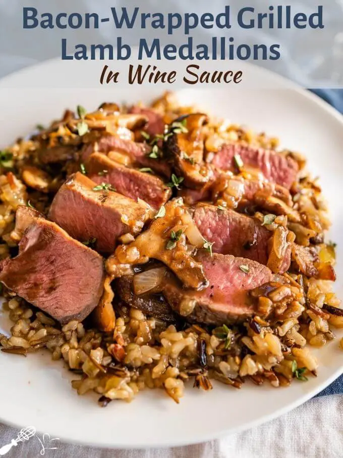 A white plate of medium-rare sliced lamb medallions on a bed of wild rice with a wine sauce drizzled over the top. The title \"Grilled Aussie Lamb Medallions in Red Wine Sauce\" banner runs across the top of the photo
