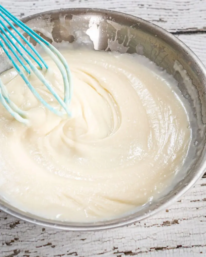 Top down view of a slurry made of flour, butter and milk in a skillet.