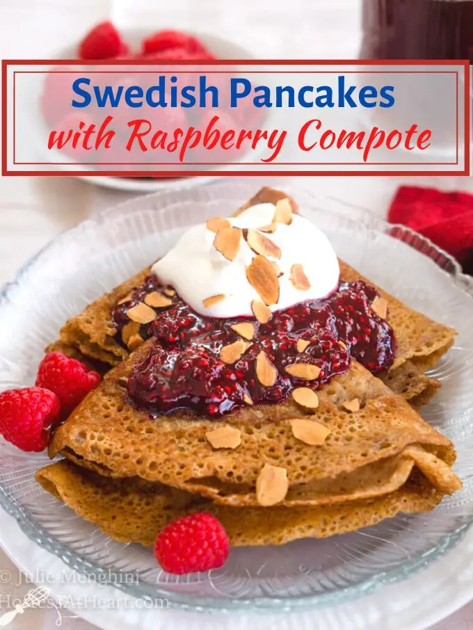 A folded Swedish Pancake on a glass plate loaded with a red raspberry compote and whipped topping. Three red raspberries sit next to the pancake. The title \"Swedish Pancakes with Raspberry Compote\" appears over the top of the photo.