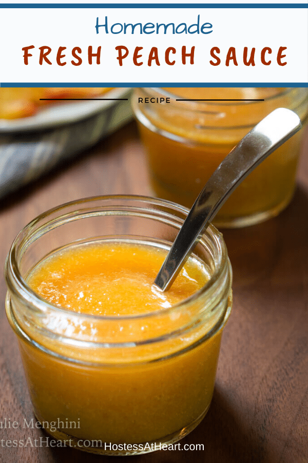 A jar of peach sauce with a spoon sitting in it over a wooden board. A second jar sits in the background. The title "Homemade Fresh Peach Sauce runs across the top.