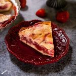 A slice of strawberry kuchen dessert with a creamy custard strawberry filling. Hostess At Heart