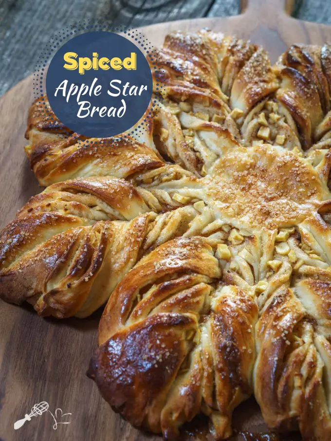 3/4 view of a star shaped loaf of bread on a wooden cutting board.