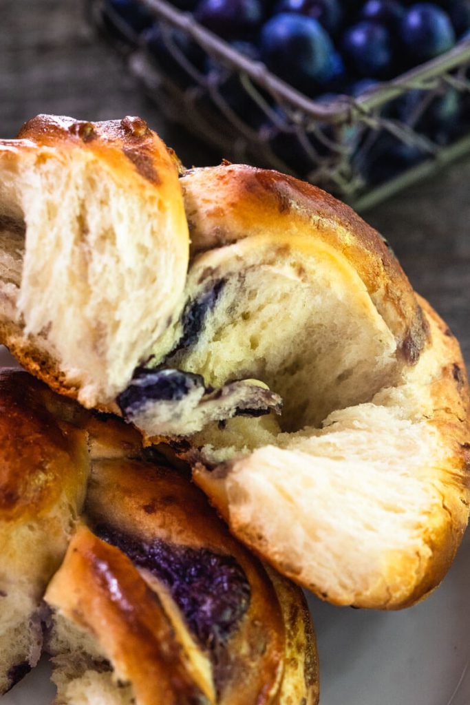 Close-up view of a Blueberry Twist Roll split in half showing the blueberry scream filling.