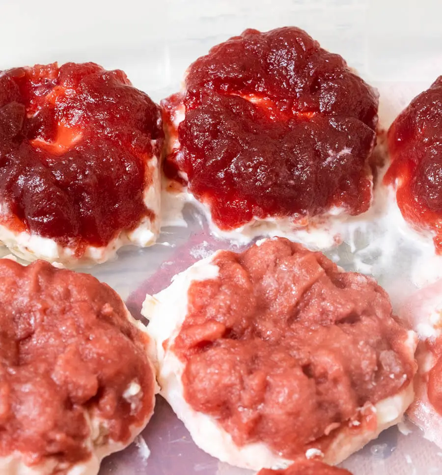 Individual Frozen Cranberry Salad servings frozen on a baking sheet.