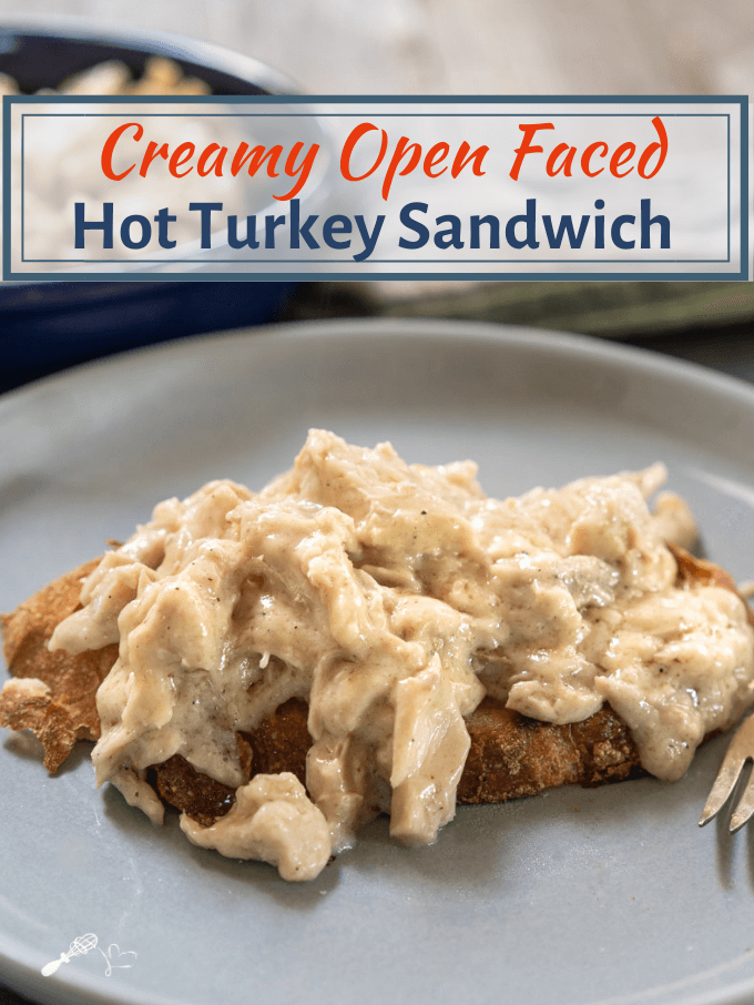 Crusty bread topped with creamy turkey filling on a gray plate.