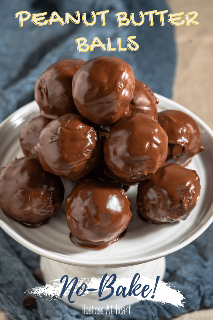 Side view of a stack of chocolate balls sitting on a white cake stand.