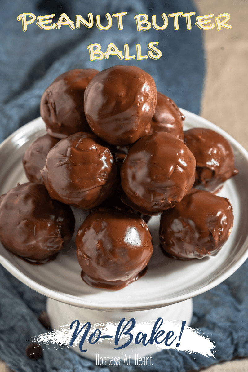 Side view of a stack of chocolate balls sitting on a white cake stand.