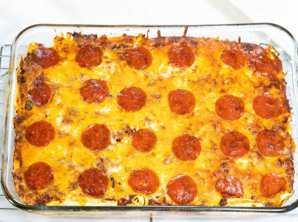 Top down view of a cheesy casserole topped with pepperoni.
